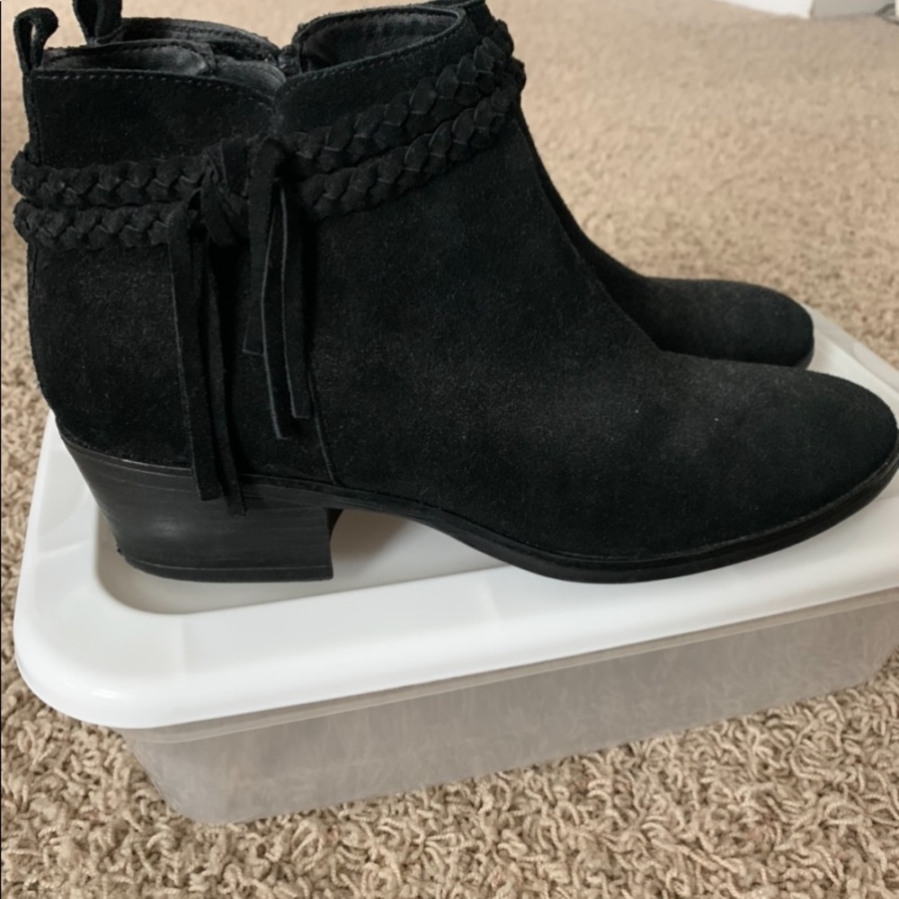 Black boot with zipper and a tassel.
